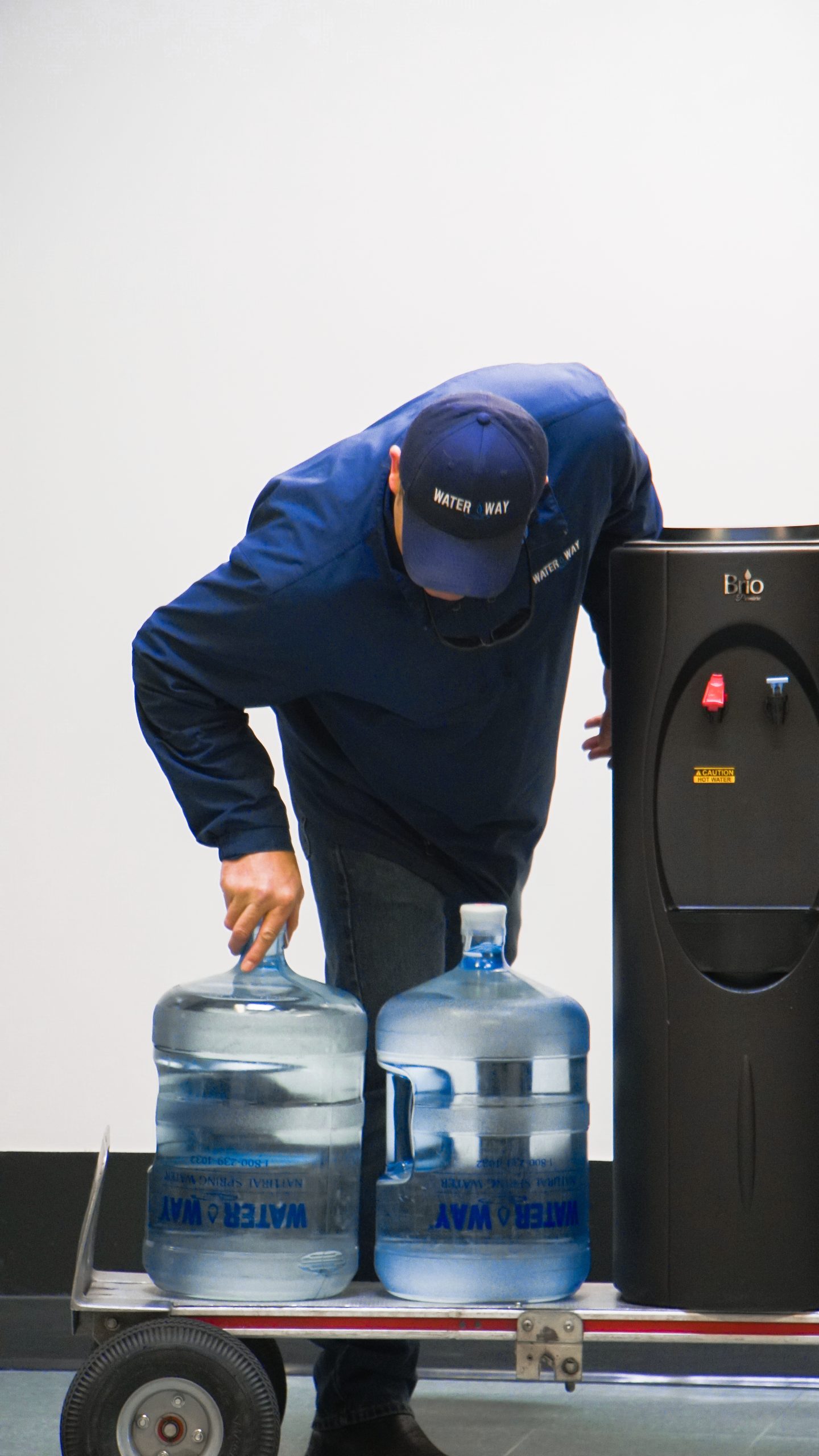 man replacing water